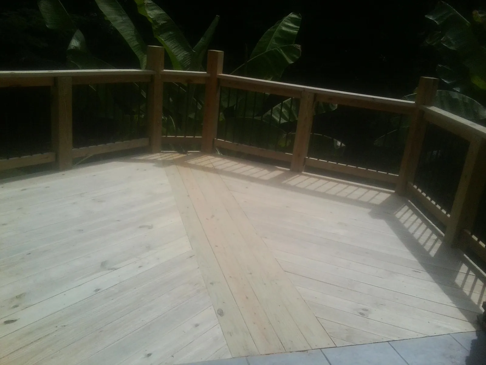 New wood deck and railing built off the back of a home in Kiowa